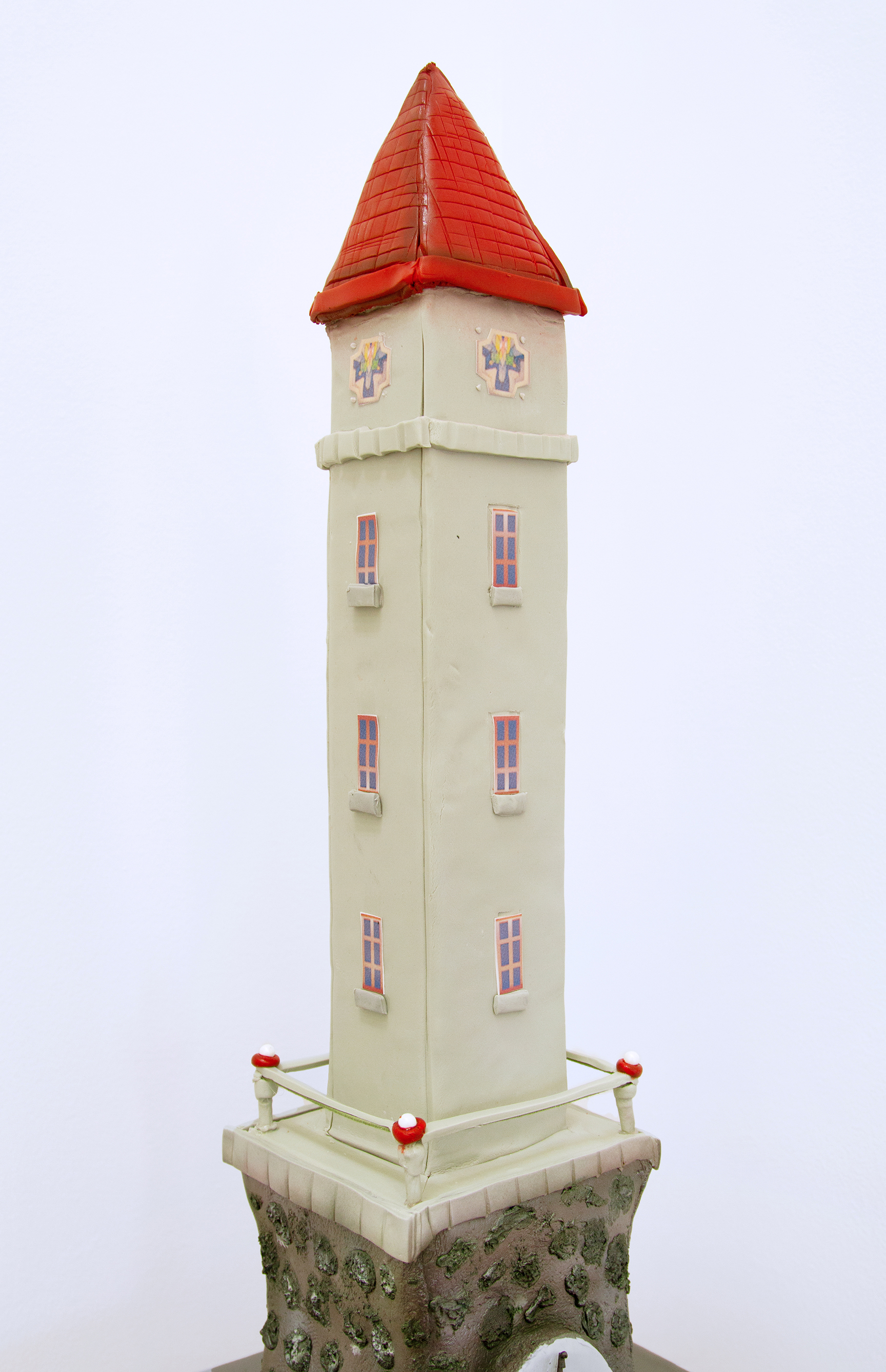 Detail of a tower shaped cake on a wooden pedestal
